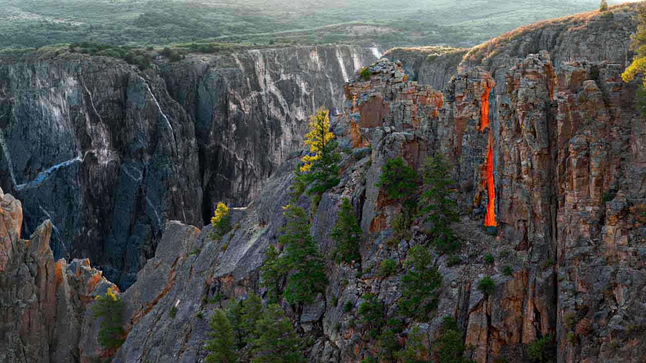 The glowing red dragon's tongue of the Black Canyon in the state of Colorado in the United States. Photograph by Amar Guillen, photographer artist.