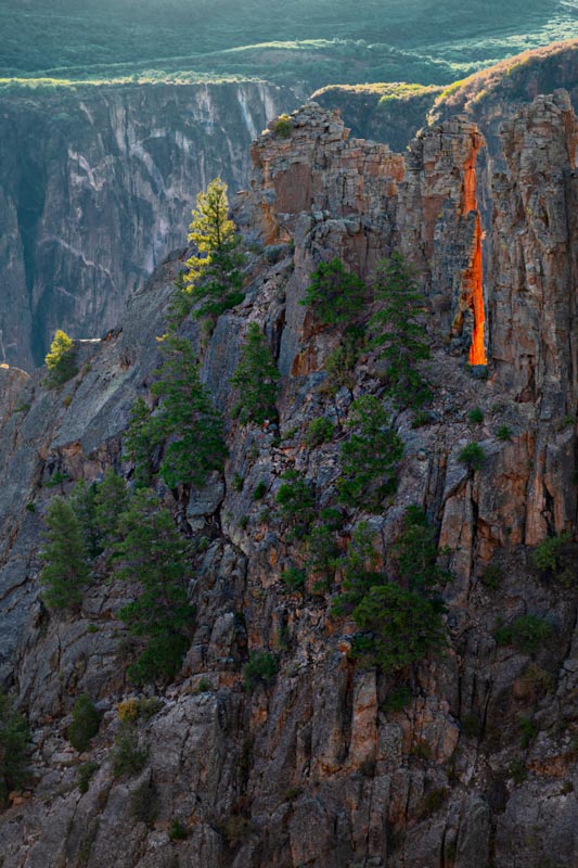 The glowing red dragon's tongue of the Black Canyon in the state of Colorado in the United States. Photograph by Amar Guillen, photographer artist.