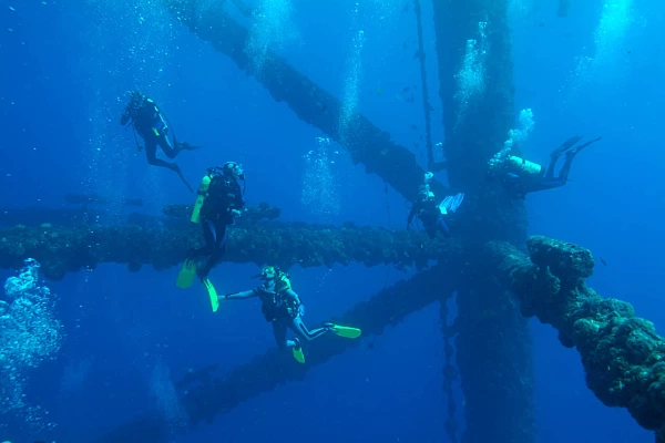 Diving on Oil Platforms in the Gulf of Mexico off Texas, USA Scuba divers around an oil rig in the Gulf of Mexico off Texas coast.