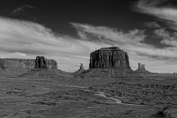 A Good Photo Should Tell a Story and Generate Interest Photograph in black and white of a landscape of Monument Valley. Photograph by Amar Guillen, photographer artist.